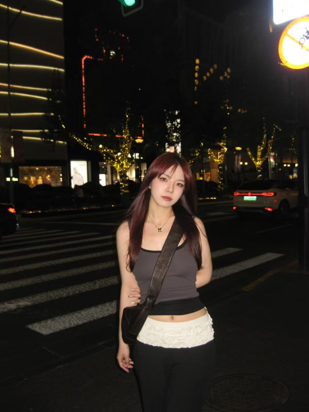 Shan at a city crossing at night